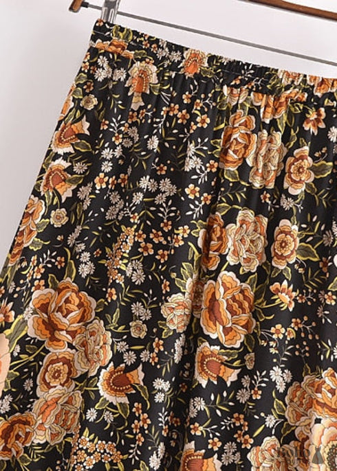 Faldas bohemias con estampado Maryam de flores negras y doradas para mujer