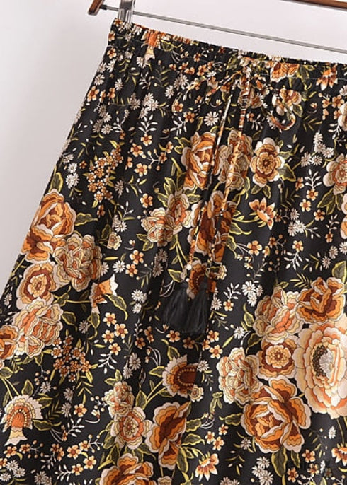 Faldas bohemias con estampado Maryam de flores negras y doradas para mujer